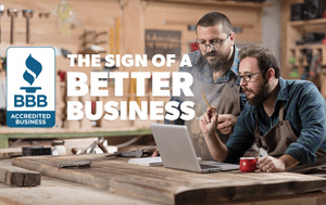 Image with Carpenters looking at laptop screen, pencil in one hand coffee mug in other. Accredited Business The Sign of a Better Business overlay